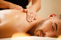 closeup-man-enjoying-relaxing-back-massage-with-honey-spa